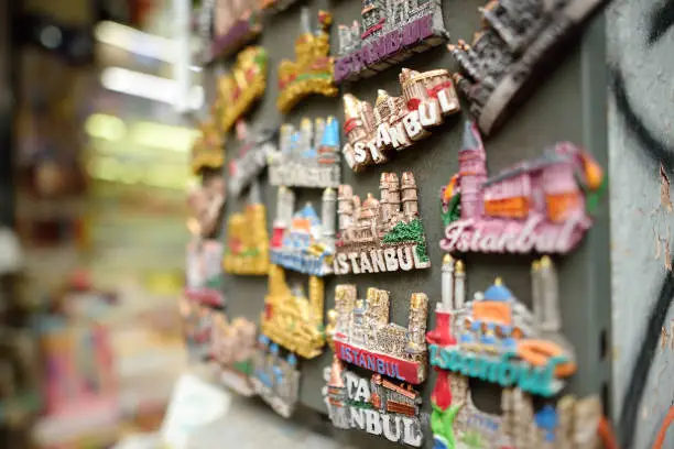 Photo of Sale of magnets, postcards, bottle openers, bookmarks, calendars, key rings and other souvenirs on the street of Istanbul. Gift and keepsakes from travels by Turkey.