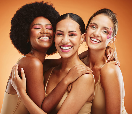 Beauty, skincare and diversity with model woman friends on a brown background in studio for health or wellness. Portrait, empowerment and natural with a female group posing together for inclusion