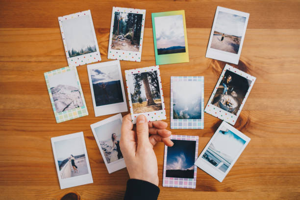 istock Woman holding instant photos from a trip 1448823084