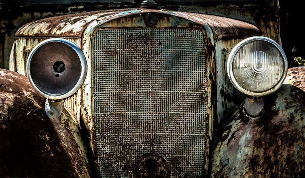 istock Front part of an old abandoned car with broken headlights and rusty grill 1448823286