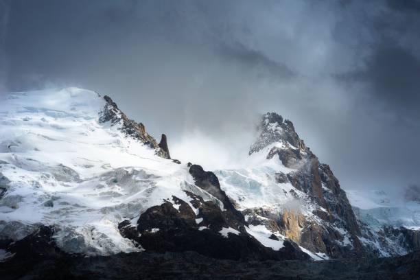 istock Breathtaking snowy mountain covered in fog 1448823719