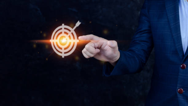 istock Businessman touching virtual dartboard with arrow ,Business Achievement objective target concept.for setup business objective target concept. 1448825595
