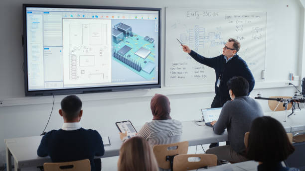 istock Male Teacher Explains About Computer Motherboard Components to Students During Lesson at University. Using Interactive Whiteboard. 3D Modelling of Circuit Board for Equipment Concept. 1448836953