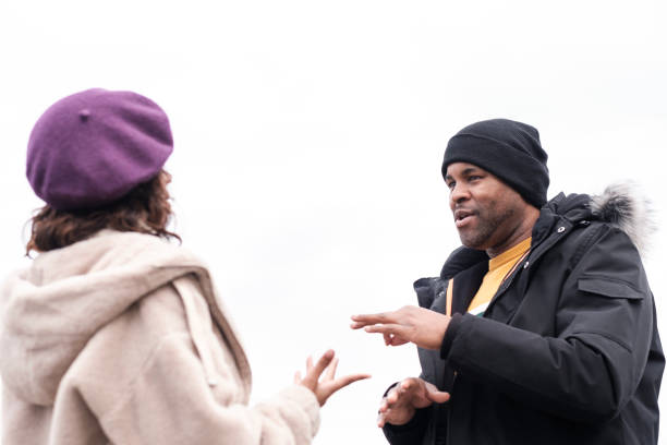 istock Deaf afro american man is using sign language to talk his friend. 1448838097