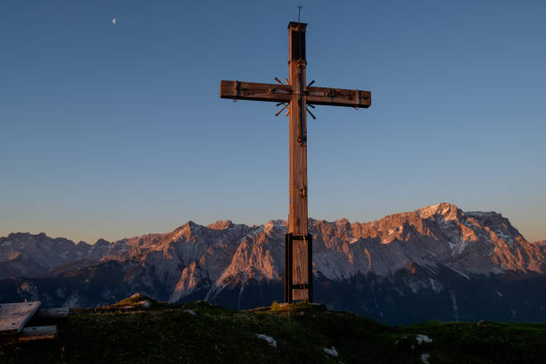 An evening at the summit cross with a view of the Zugspitze stock photo