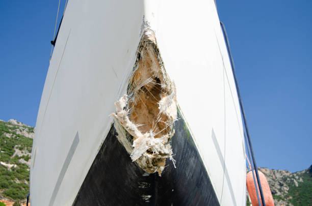 The collision-damaged bow of the fiberglass sailboat stock photo