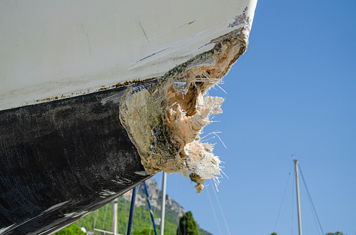 The collision-damaged bow of the fiberglass yacht.