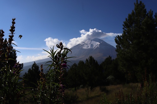 A landscape view Popocatepetl volcano with cloudy sky background