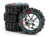 Spare new set of winter tires with snow chains isolated on white
