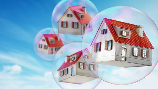 Houses floating in the air inside soap bubbles. Housing bubble concept.