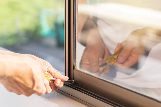 istock A man using a screwdriver to adjust a screw in a window 1448848579