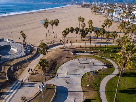 Aerial photography of the venice beach boardwalk, shops, vendors, venice skate park, roller skating area, graffiti walls, beach, and other public areas. Photos taken with a drone during the December in Los Angeles.