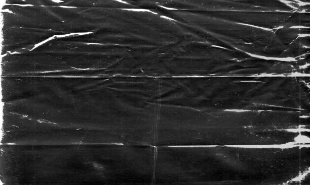 istock Background texture of a polyethylene, plastic transparent black plastic film, transparent stretched black and white metaverse crypto blockchain background 1448862551