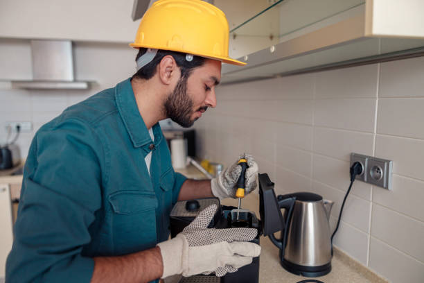 istock Man with screwdriver fixing coffee machine at table in kitchen. Maintenance and repair concept 1448865680