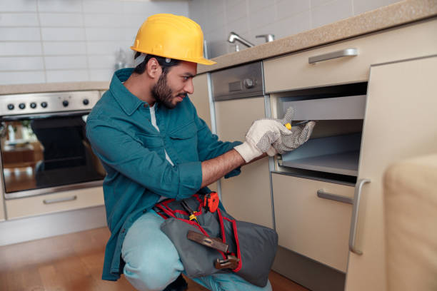 istock Focused professional worker in uniform is assembling furniture on kitchen. Repair concept 1448865681