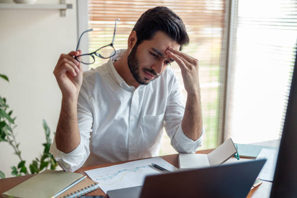 istock Tired indian businessman with headache working from home office 1448866111