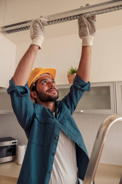 istock Professional electrician worker in uniform is installing electric lamps light in kitchen 1448866274
