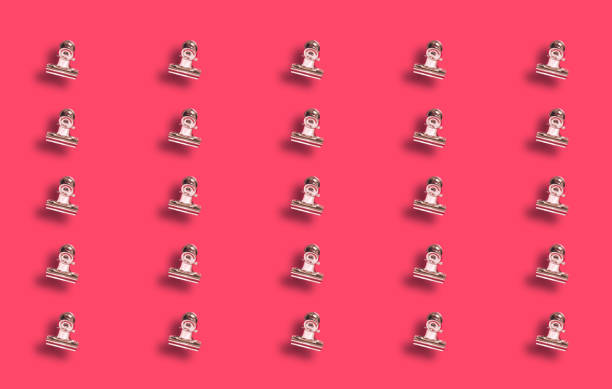 istock Paoer clamps on red background. 1448868435