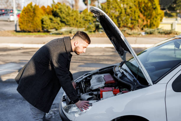 istock A young handsome man had a car accident on the road and trying to fix the problem. 1448870103