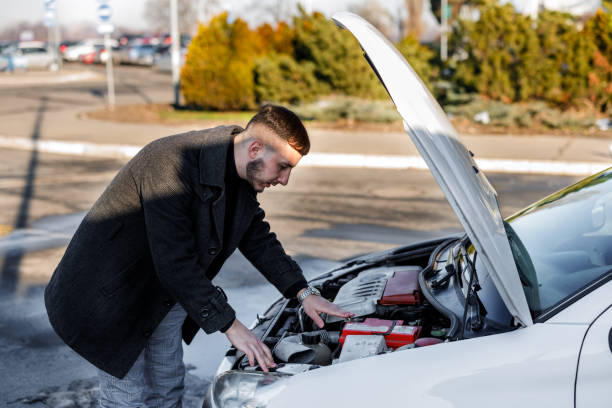 istock A young handsome man had a car accident on the road and trying to fix the problem. 1448870370