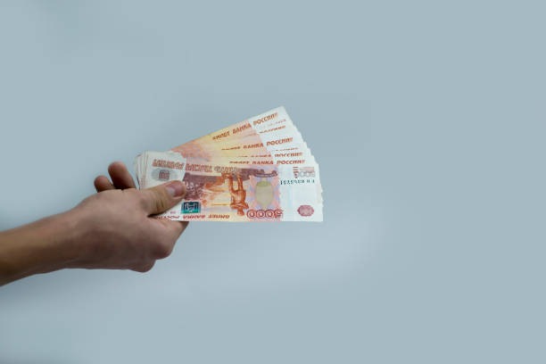 istock The hand holds 5 thousand rubles. Recalculation of funds. 1448871310