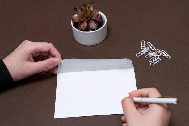 istock Woman Hand Holding Blank Notes Envelope Writing New Messege Updates Ideas. 1448873183