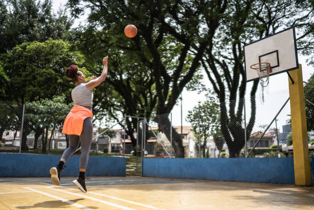 istock Young woman playing basketball 1448876508