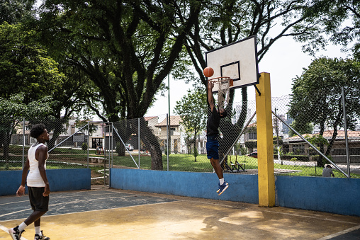 Glass or transparent plastic sports board to play basketball seen from below. Side and low angle view. Free throw or triple. Sport concept.