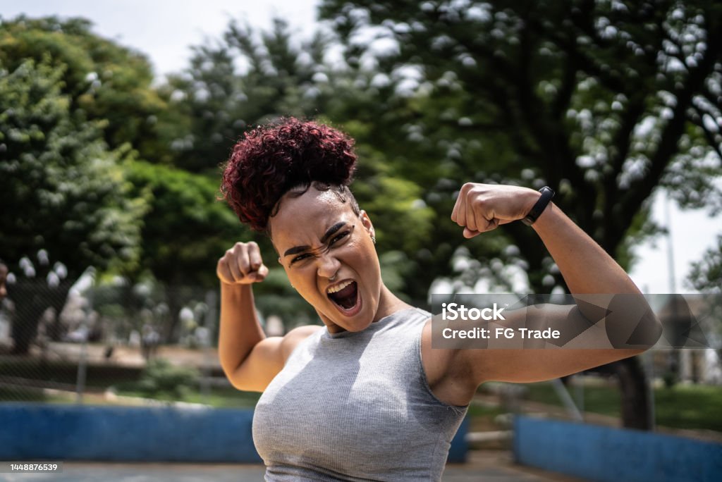 Portrait of a young woman celebrating at a sports court Confidence Stock Photo