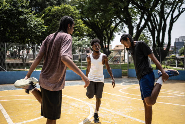 istock Young men stretching at a sport court 1448876742