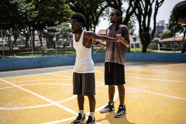 istock Young men stretching at a sport court 1448876808