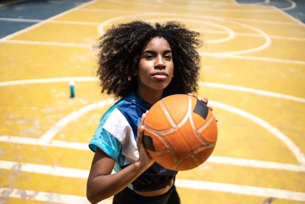 istock Young woman playing basketball 1448878222