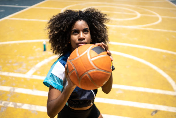 istock Young woman playing basketball 1448878232