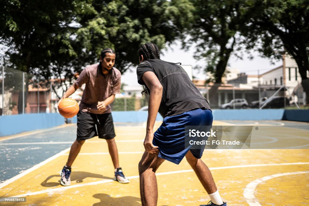 Young men playing basketball Basketball - Sport Stock Photo