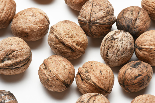 Directly above group of walnuts on the white background