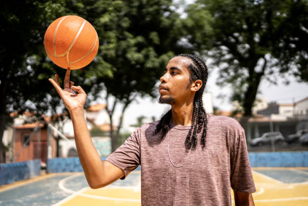 istock Young man spinning a basketball ball 1448878943