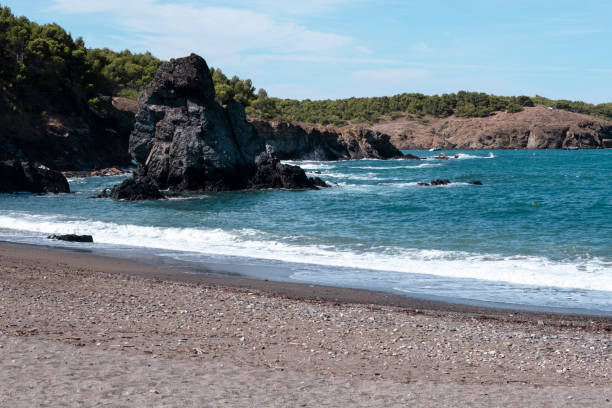 istock Cliff rocks on a sandy beach shore summer landscape in Costa Brava, Catalonia 1448880211