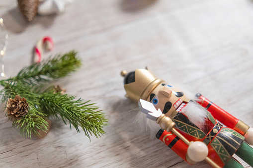 Christmas nutcracker figurine. Christmas tree and presents, bokeh background.