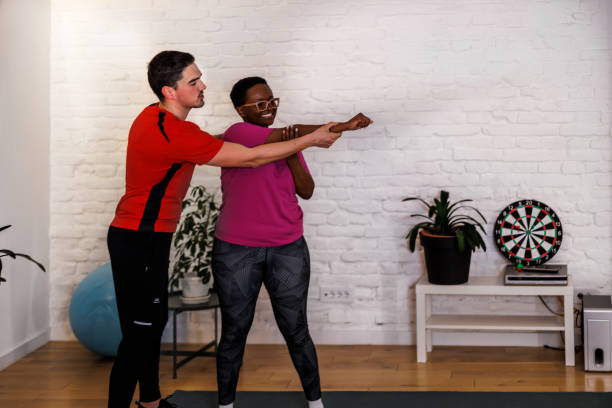 istock A multiracial couple is preparing for a home workout while stretching. 1448883907