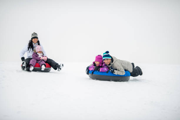 istock Family Tubing Together 1448885872