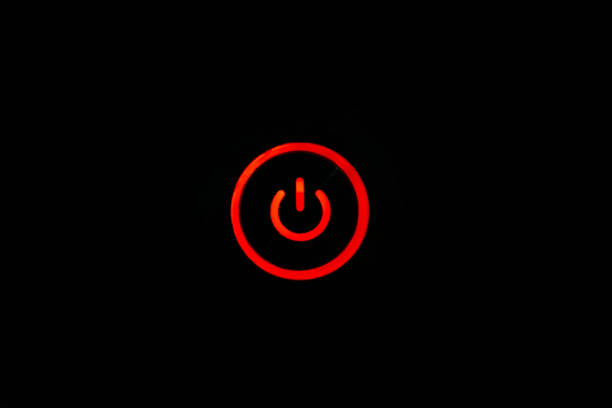 istock Power button in red color on dark background. Power button backlighted 1448887918