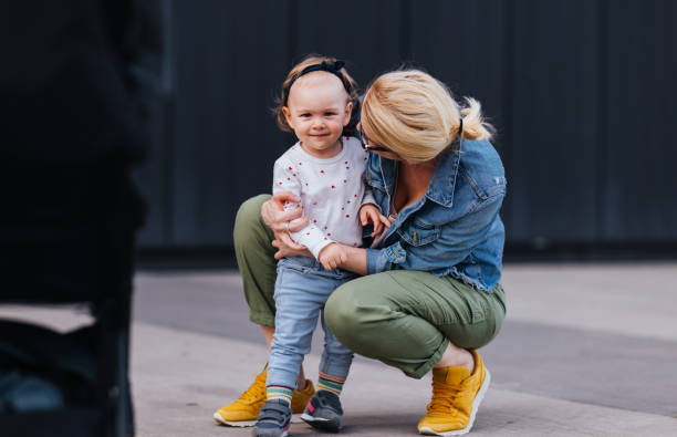 istock Single Mom Hugging Her Daughter While on a Walk in the City 1448889603