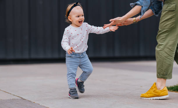 istock Adorable Girl Playing Outside With Her Anonymous Mom 1448889724