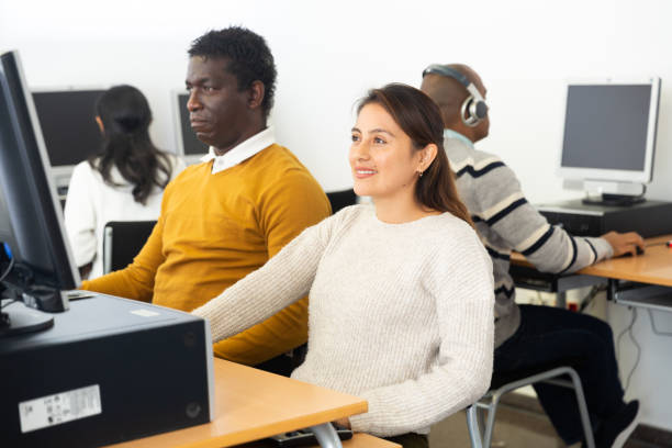 istock Young adult woman studying in computer class 1448891132