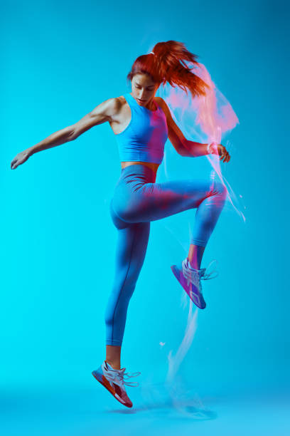 istock A fit sportswoman is jumping and doing exercises. 1448898702