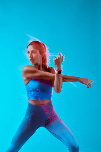 istock A muscular sportswoman doing workouts in studio. Long exposure capture movement. 1448898877