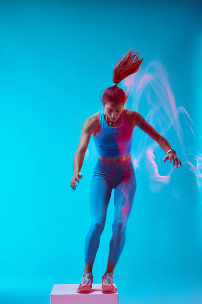 istock A sportswoman is doing box jumps and exercising. Long exposure capture movement. 1448899065