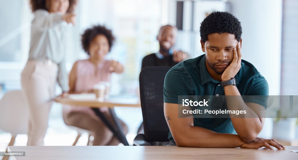 Workplace bullying, depression and gossip of businessman with anxiety, mental health and pointing employees in office conflict. Lonely, depressed and harassment of sad victim in worker discrimination Working Stock Photo