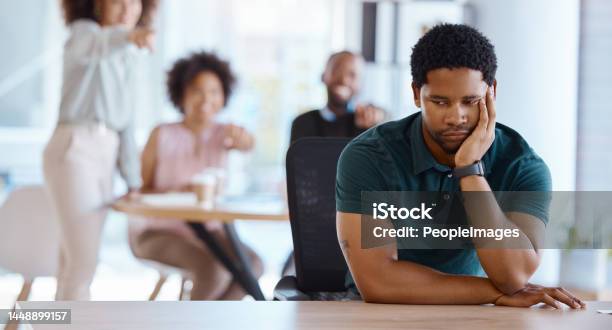Workplace Bullying Depression And Gossip Of Businessman With Anxiety Mental Health And Pointing Employees In Office Conflict Lonely Depressed And Harassment Of Sad Victim In Worker Discrimination Stock Photo - Download Image Now