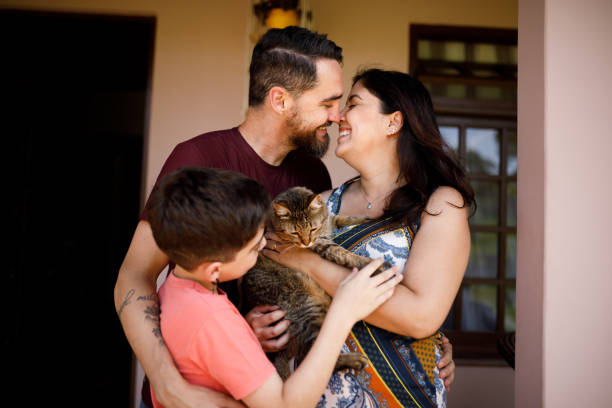 istock Small affectionate family with a pet cat 1448901921